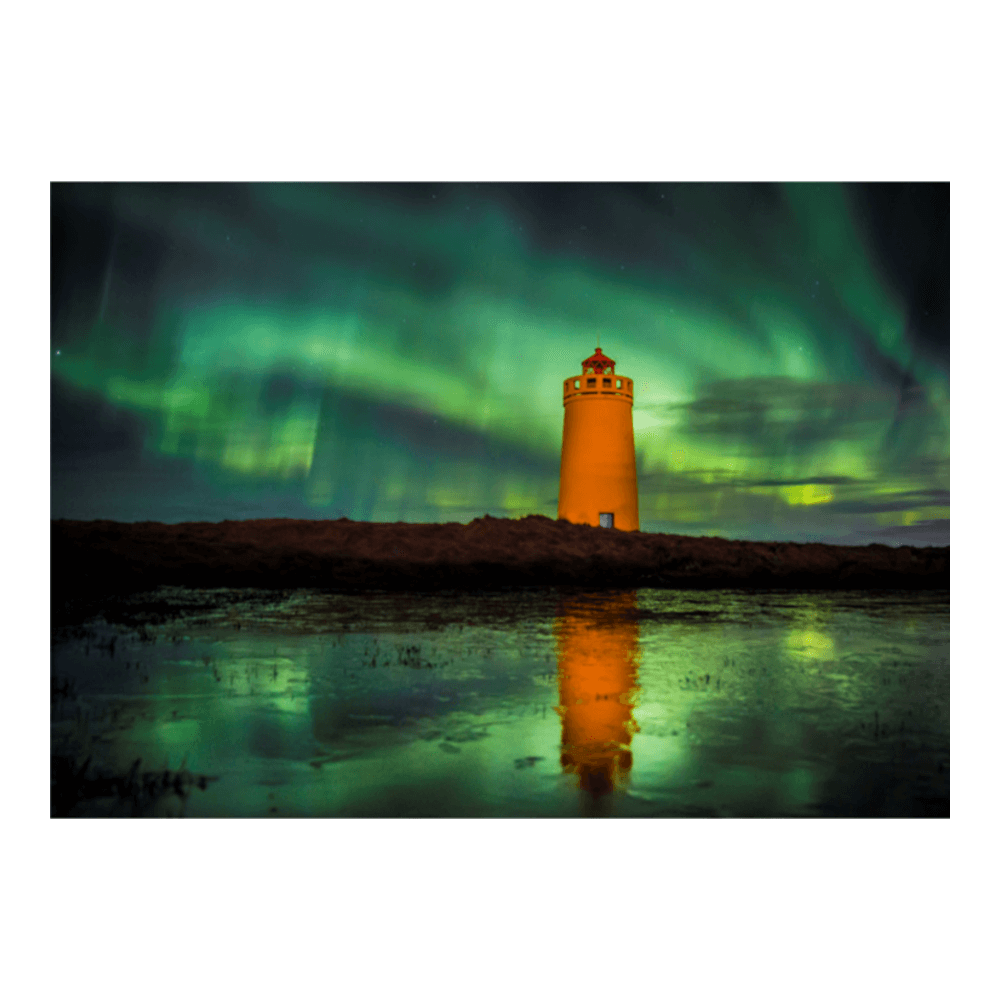 Iceland in summer — vivid green rolling hills under a bright blue sky with cotton-wool clouds